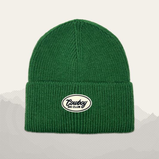 Pine Green — chunky ribbed knit beanie with oval Cowboy Ski Club patch on cuff, front flat lay